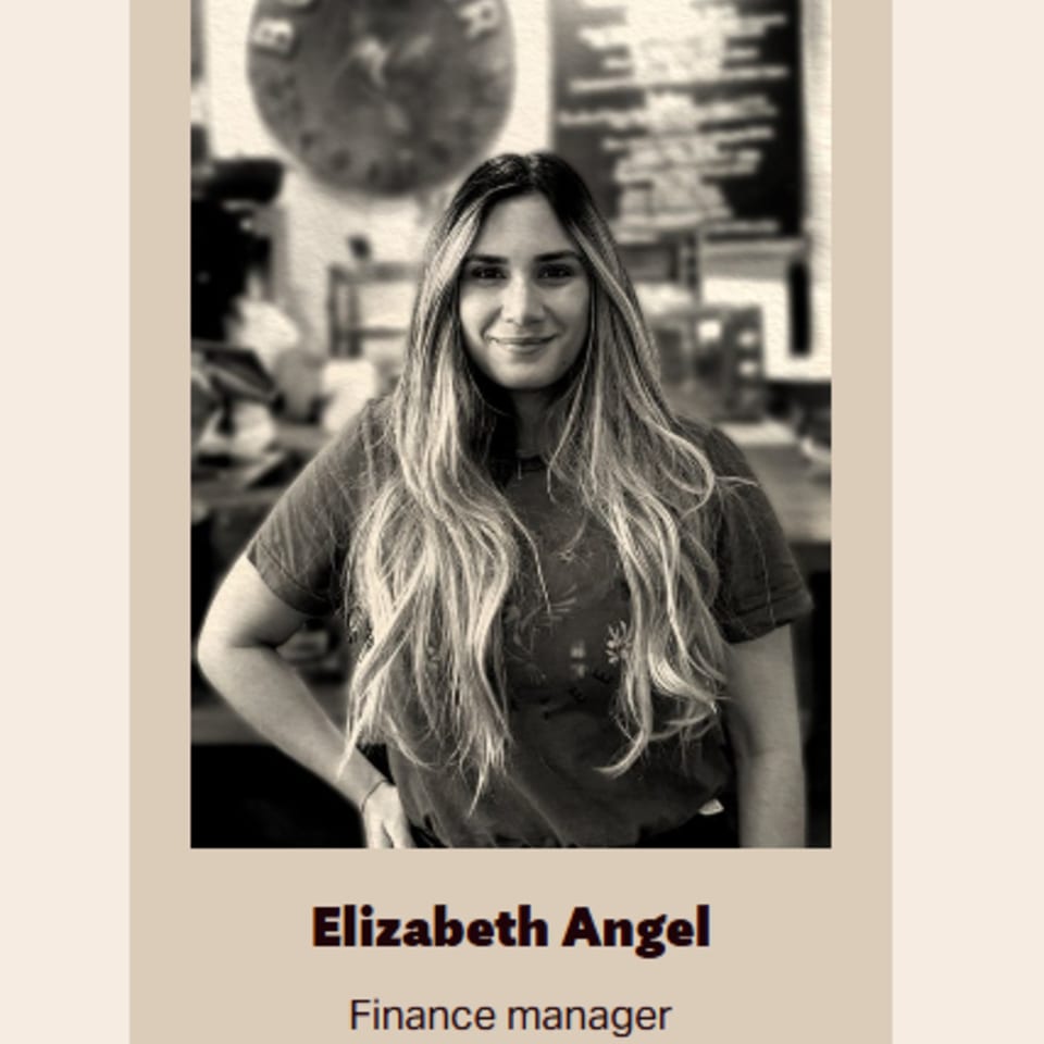 Black and white portrait of Elizabeth Angel, Bolivar Coffee's Finance Manager, smiling.