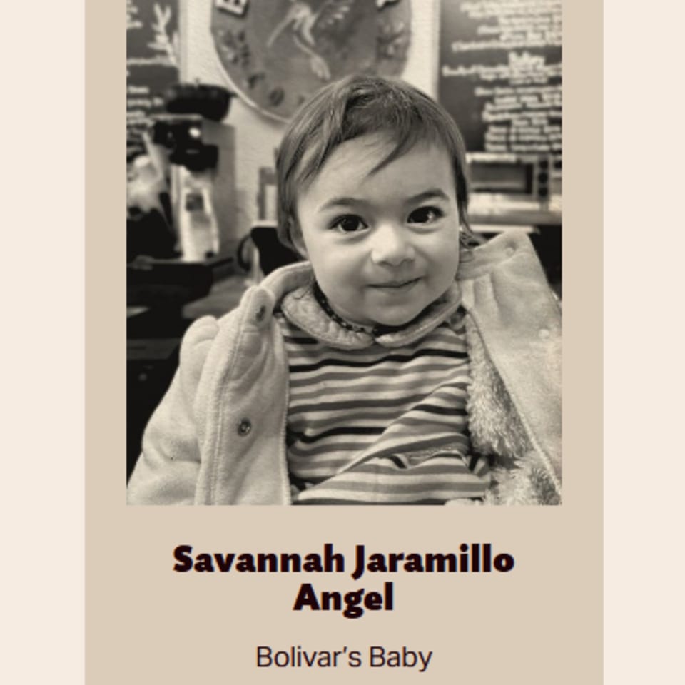 A smiling baby, Savannah Jaramillo, in a striped shirt and jacket, at Bolivar Coffee.