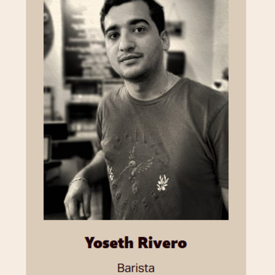 Black and white portrait of Bolivar Coffee barista Yoseth Rivero, leaning with a subtle smile.